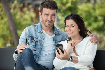 couple sitting on outdoor seat together