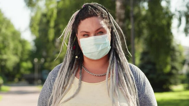 Portrait of female body possitive caucasian women or adult girl wear medical face mask greeting with camera. Health care and medical concept of coronavirus protection covid 19 spreading prevention
