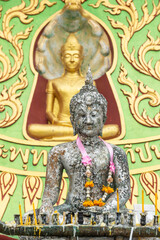 Fototapeta na wymiar Buddha sculptures in colorful temple of Thailand, very traditional