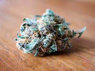 Cannabis bud on a wooden surface