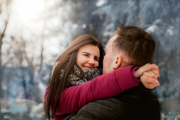 Fototapeta premium hugs of lovers in winter. Warm hugs of loved ones. Winter fairy tale and love story