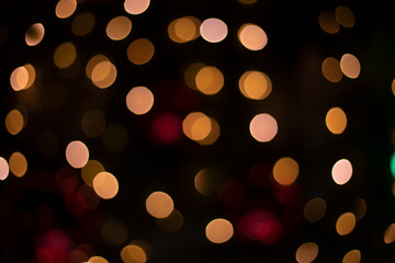 Christmas lights on black background abstract unfocused wallpaper festive concept