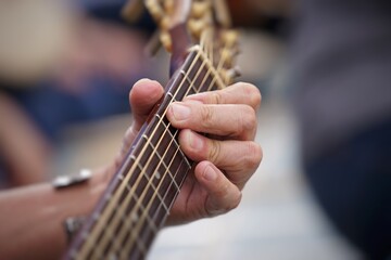 close up of a person playing guitar