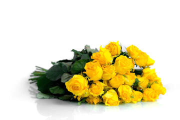 A bouquet of wilted yellow roses lies on a white background