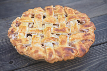Homemade Apple Pie with lattice crust on a vintage wooden table