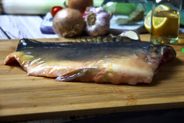 Raw fresh carp fish on a cutting board. Cooking background.