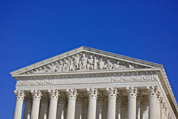 West pediment of the exterior of the US Supreme Court building in Washington, DC with Copy Space of sky above