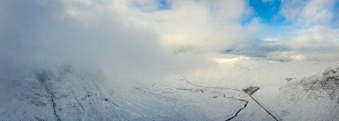 a view of buachaille etive mor and rannoch moor in winter in the argyll region of the highlands of scotland showing snow dusting on the mountains and munros