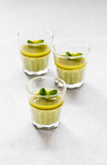 Italian Panna Cotta green matcha tea in a glass on a light gray background