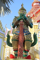 Guardian giant is standing in front of church Buddhist temple closeup.
