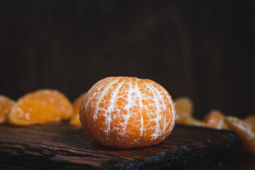 Fresh and juicy tangerine or mandarin on cutting board on table  closeup