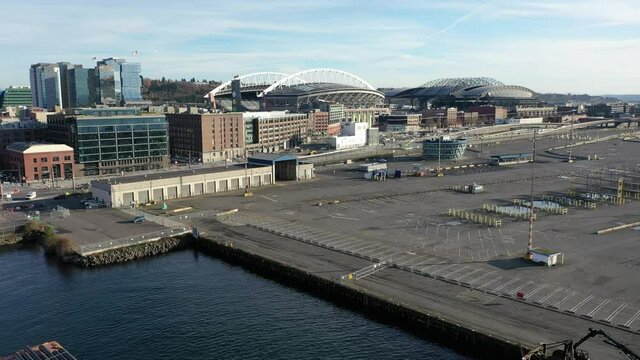 Aerial / drone footage of Seattle harbor terminal 49 by the waterfront, Duwamish Waterway, Elliott Bay, Pike Place with few people downtown, the commercial district of Seattle, Washington during COVID