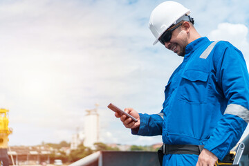 Navy deck officer holding a mobile phone