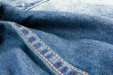 clothing items blue stonewashed faded jeans cotton fabric texture with seams, clasps, buttons and...