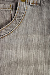 clothing items stonewashed cotton fabric texture with seams, clasps, buttons and rivets, macro