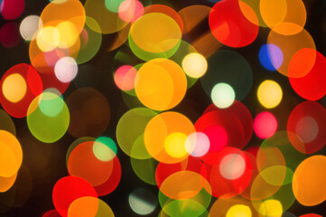 Christmas background-garlands with colorful lights on a decorated Christmas tree, bokeh