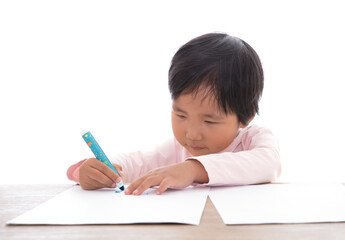 Little girl drawing seriously on the table in front of white background