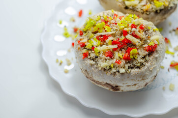 Mushrooms stuffed with onion, garlic, leek, paprika and sprinkled with cheese and breadcrumbs, snack prepared for baking