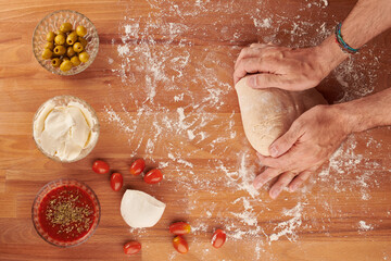Making italian pizza step by step: kneading the dough