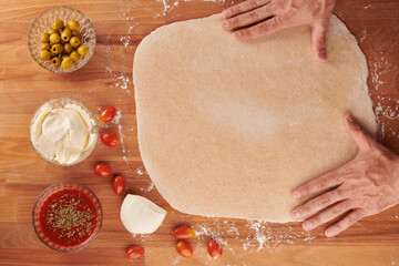 Making italian pizza step by step: ready rolled out dough