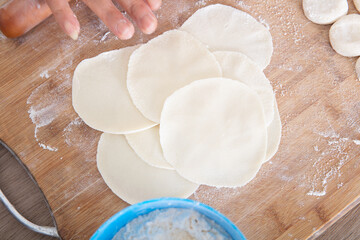 Looking down and shooting the pressed dumpling wrappers on the cutting board