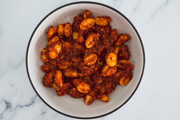 plant-based food,  vegan potato gnocchi with olive red pesto