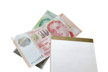 Notebook stacked on Singapore banknotes isolated on white