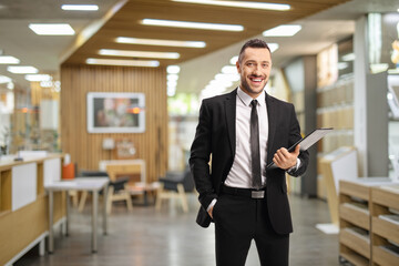 Salesman holding a clipboard inside a shop