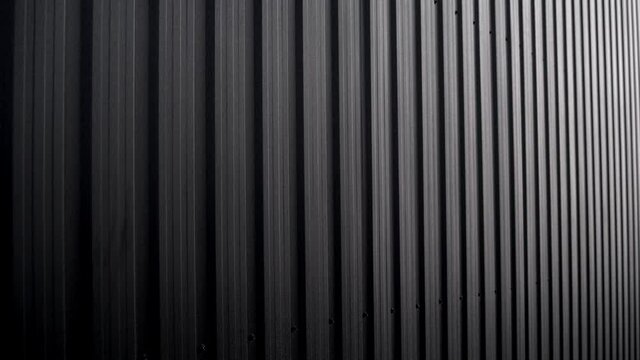 Black Corrugated metal sheet surface of the wall. Galvanize steel background.