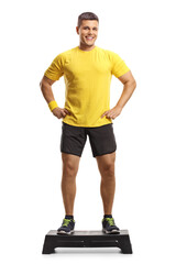 Man standing on a step aerobic platform and smiling