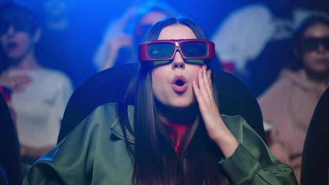 Frightened Woman Watching Horror In Cinema. Girl Feeling Scared In Movie Theater