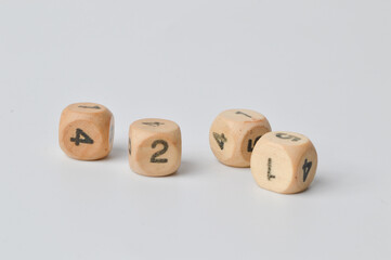 Selective focus of wooden dice isolated on a white background.