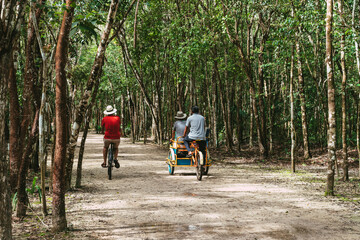 Tourist in the jungle with a backpack and a hat. Tourism in the ancient city Mayan pyramids....