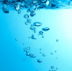 Pouring made a splash of blue waves under the water and Bubbles flowing up on water surface in...
