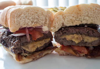 Stuffed Cheeseburger Cut Open with Melted Cheese Closeup