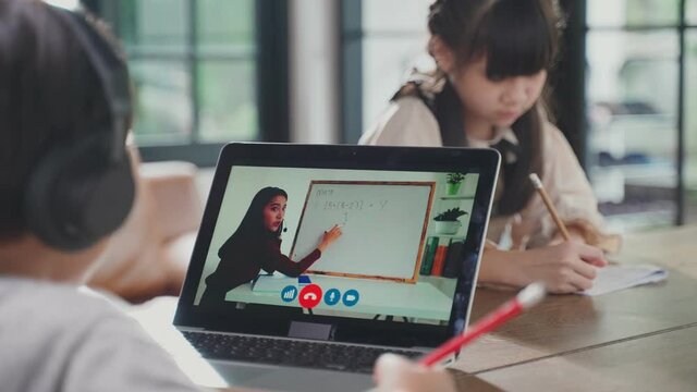 Homeschool Asian little young boy learning online class with teacher.