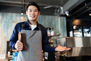 Portrait of asian waiter holding wooden tray show hand empty hand for product.