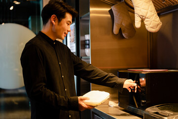 Businessman heat up lunch box in microwave in office.