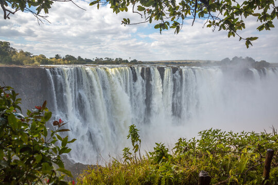 Victoria Falls. Border between Zambia and Zimbabwe. View from the rainforest. Cirrus clouds in the background © Mitya Sidor