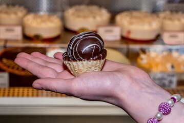hand holding a small dessert tart