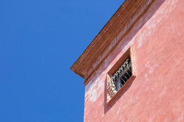 Finestra con palazzo amaranto e sfondo cielo