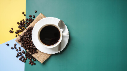 Top view of coffee cup on yellow and green and blue  background