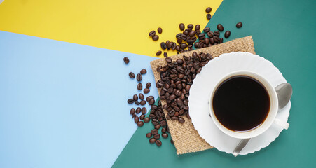Top view of coffee cup on yellow and green and blue  background