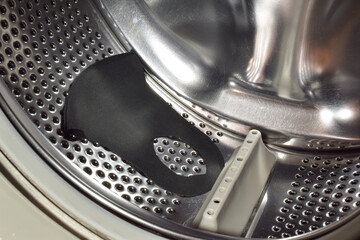 There is a washed fabric medical face mask in the drum of the washing machine