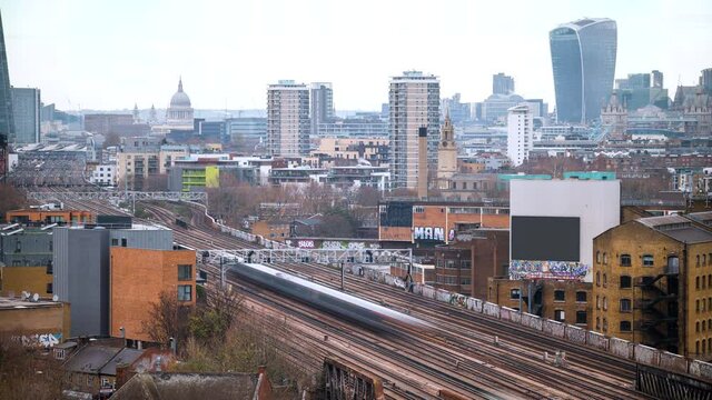 Time Lapse of trains coming to and leaving London Bridge station, shot from an elevated viewpoint with iconic landmarks on the horizon