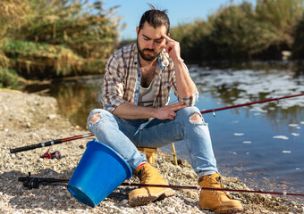 Upset fisherman displeased with fish catch. High quality photo