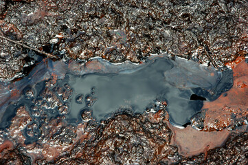 Spills of crude oil on the soil surface - environment pollution.
