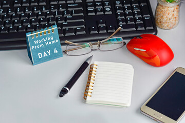 Home office desk with desktop, accessories and text written on blue note. Work from home concept