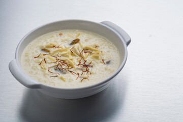 kheer or rice pudding is an Indian dessert in a bowl with dry fruits toppings