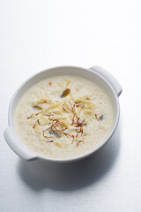 kheer or rice pudding is an Indian dessert in a bowl with dry fruits toppings
